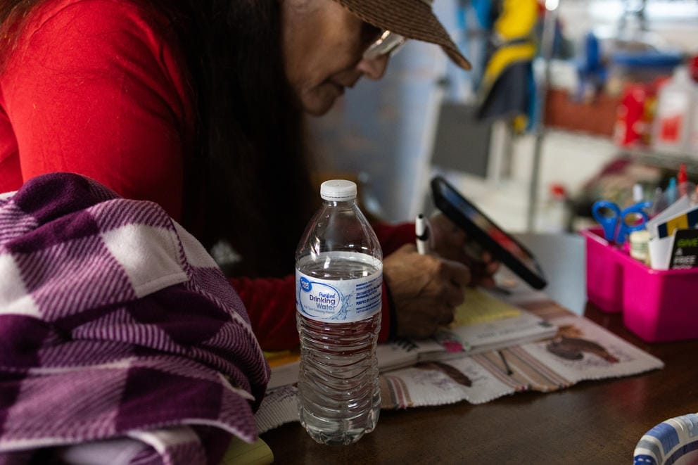 Elva Simmons is pictured on the phone with someone at the Yakima County Health District to address problems with the water system at Moxee Community.