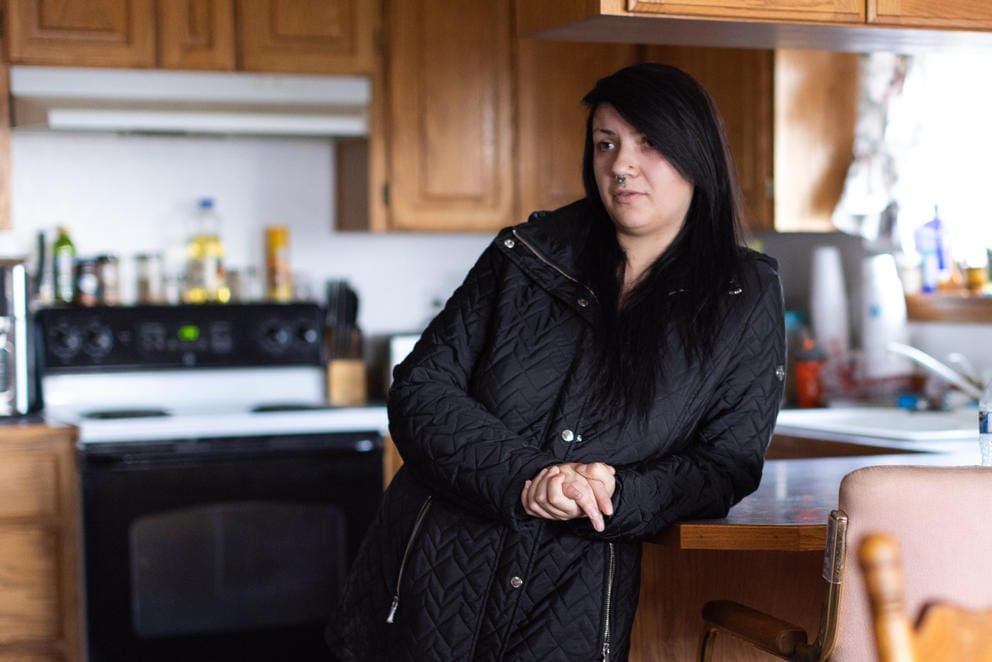 Charlotte Groo stands in the kitchen of her adoptive parents’ Bonnie and Charlie Groo’s Yakima, Wash. home.