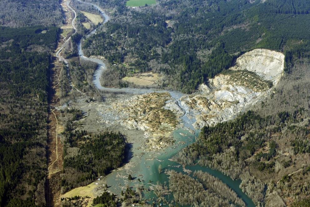 Aerial view of a massive mudslide that cut into a hillside and slid into a neighborhood.