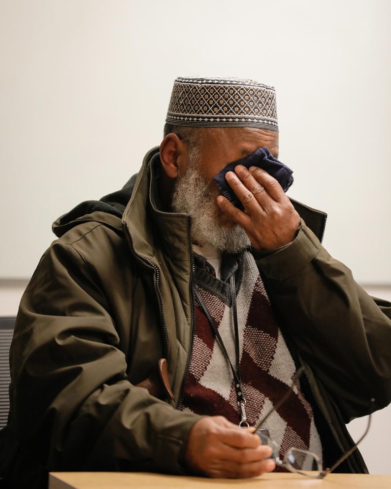 a man cries into his handkerchief
