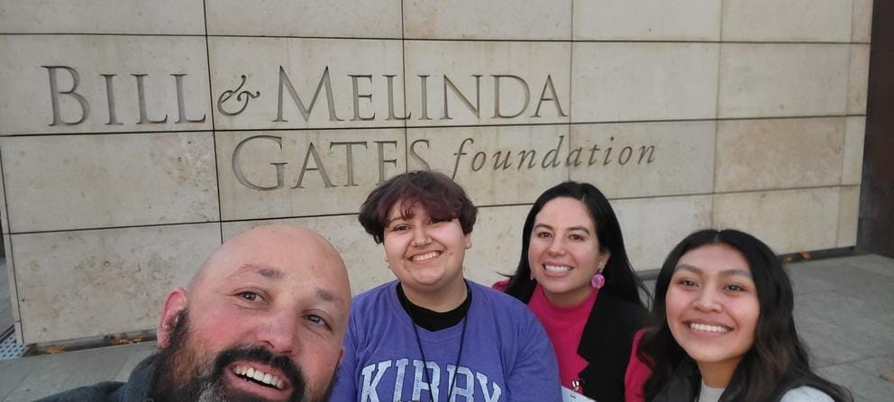 Counselor Enrique Tarver and a group of students in front of the Gates Foundation