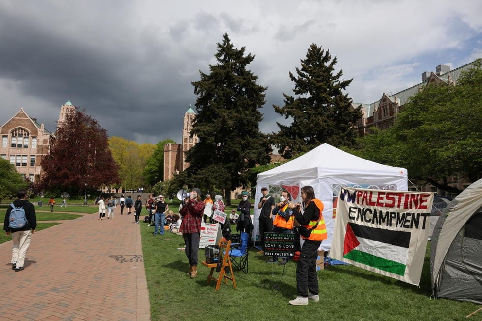 Students stand near the encampment