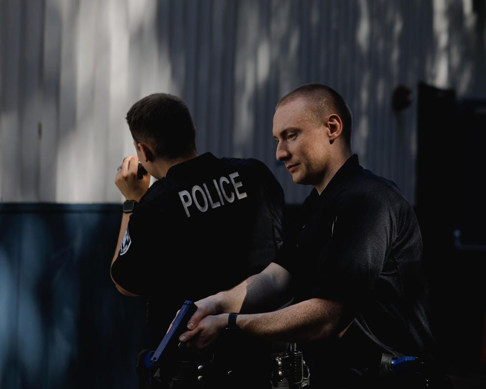 New police recruits practice clearing a building.