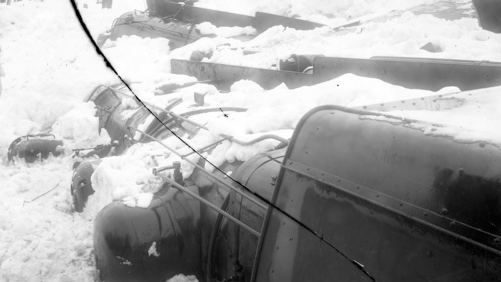 Snow covered train engines lay on their sides.