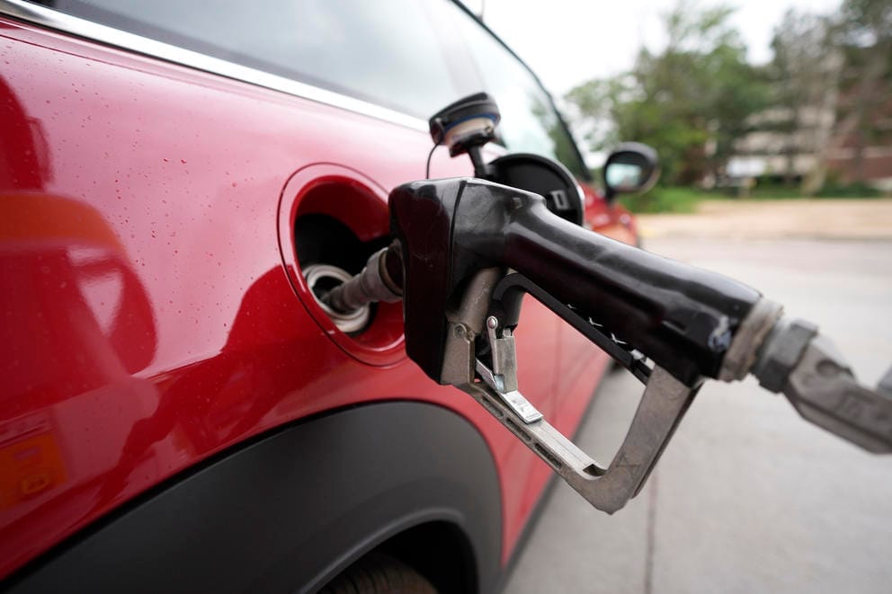 a motorist fills up the tank of a vehicle