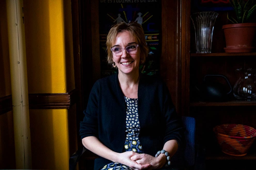 Angelina Snodgrass Godoy, Director of UW Center for Human Rights, poses for a photo at the University of Washington. She's wearing clear frame glasses and her hair is blonde, just past her ears.