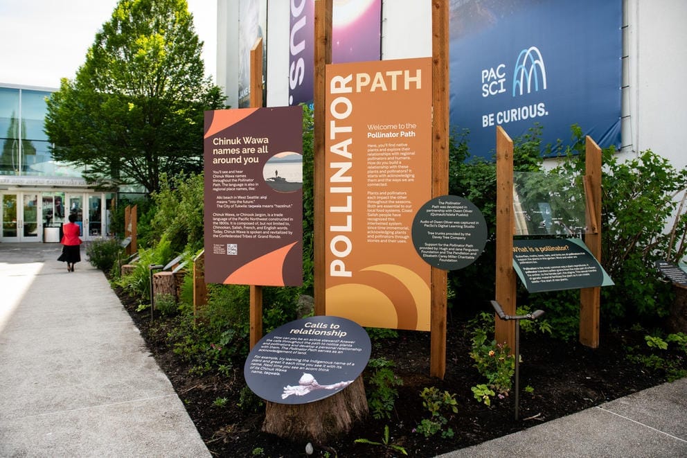 Signs welcome visitors to the Pollinator Path at the Pacific Science Center