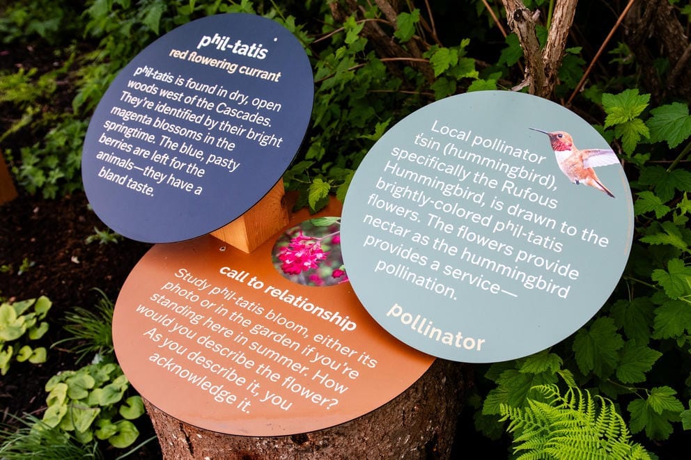 Signs welcome visitors to the Pollinator Path at the Pacific Science Center