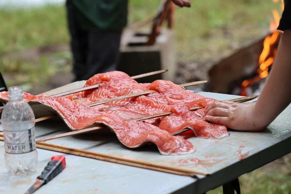 A fillet of salmon is prepared on skewers