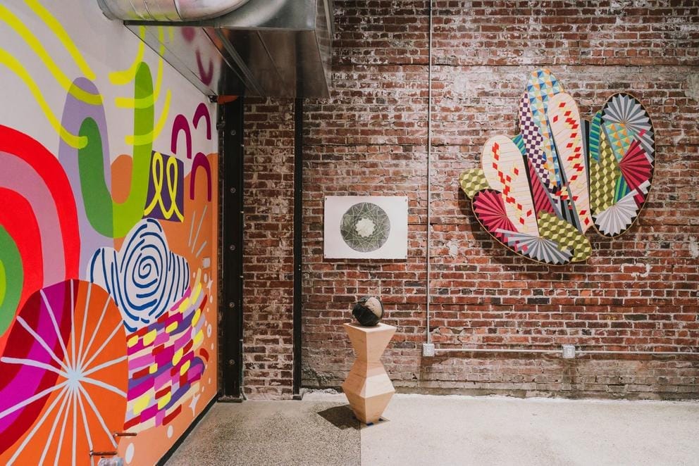 An art gallery with a brick wall