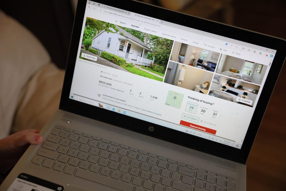 a lap top screen shows a real estate listing
