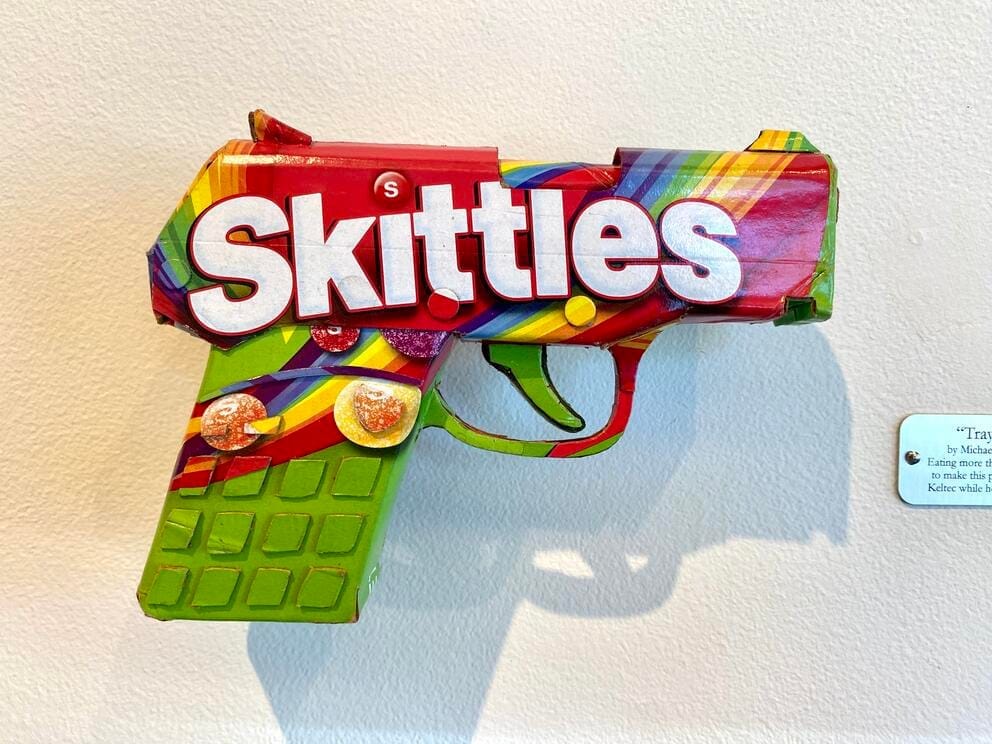 photo of a fake gun made from a cardboard Skittles box