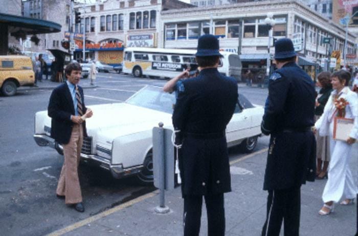 A person faces two police officers.