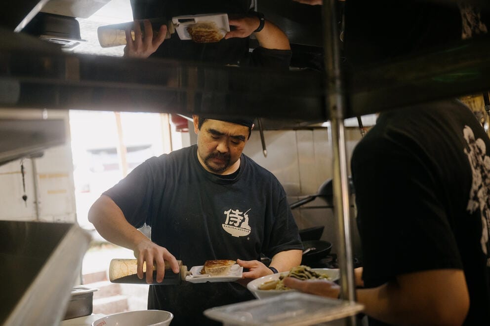 Richard Marouka cooks at Samurai Noodle on a gas stove