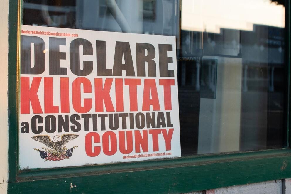 A sign in a window says