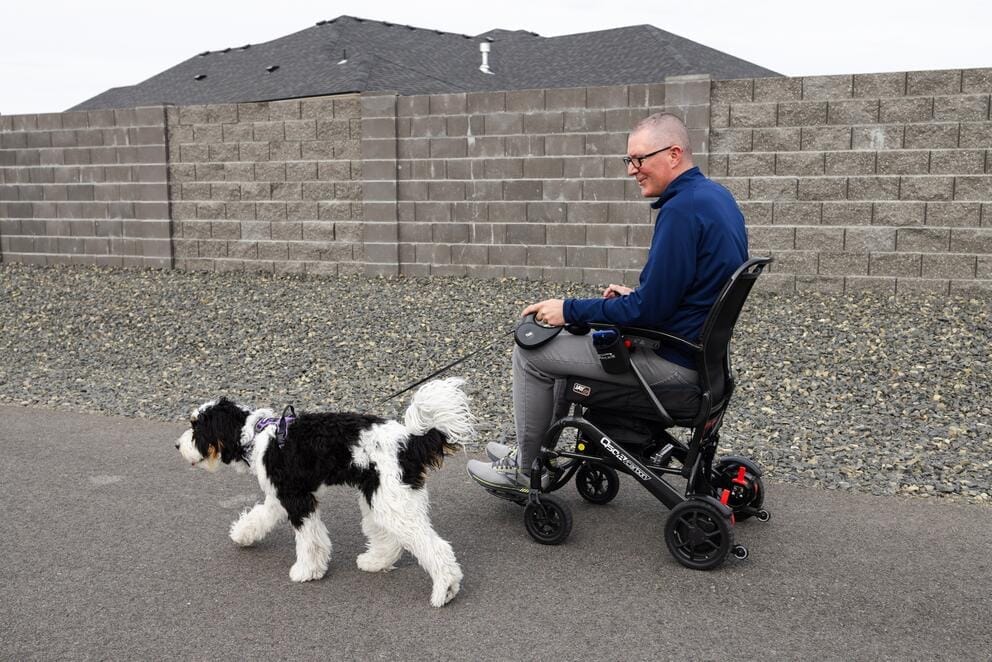 Mark Westphal walks dog in wheelchair
