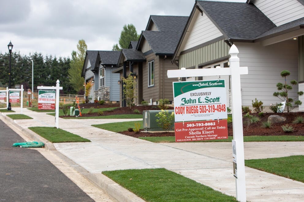 A row of for sale signs.