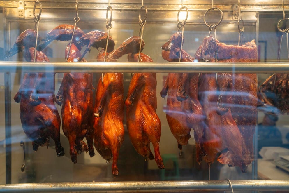 Roast duck hangs in the window of King’s Barbecue House in Seattle CID. While some prefer to stick with traditional Thanksgiving dishes, others include foods from other places in their holiday meals. (M. Scott Brauer / Cascade PBS) (M. Scott Brauer)