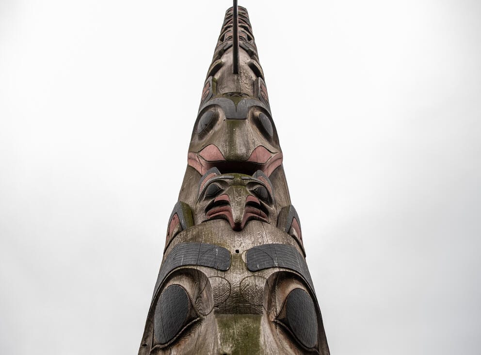 a figure at the top of a totem pole