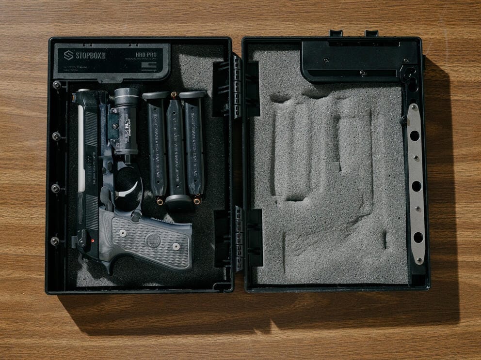 a gun sits inside a safety lock box