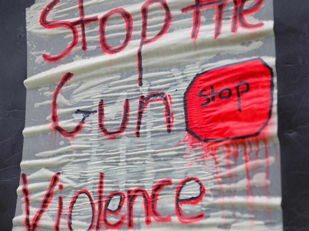 a sign reading stop the gun violence