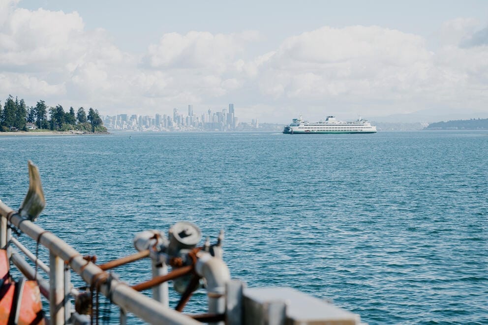 A ferry and the Seattle skyline are seen in the distance across Elliott Bay