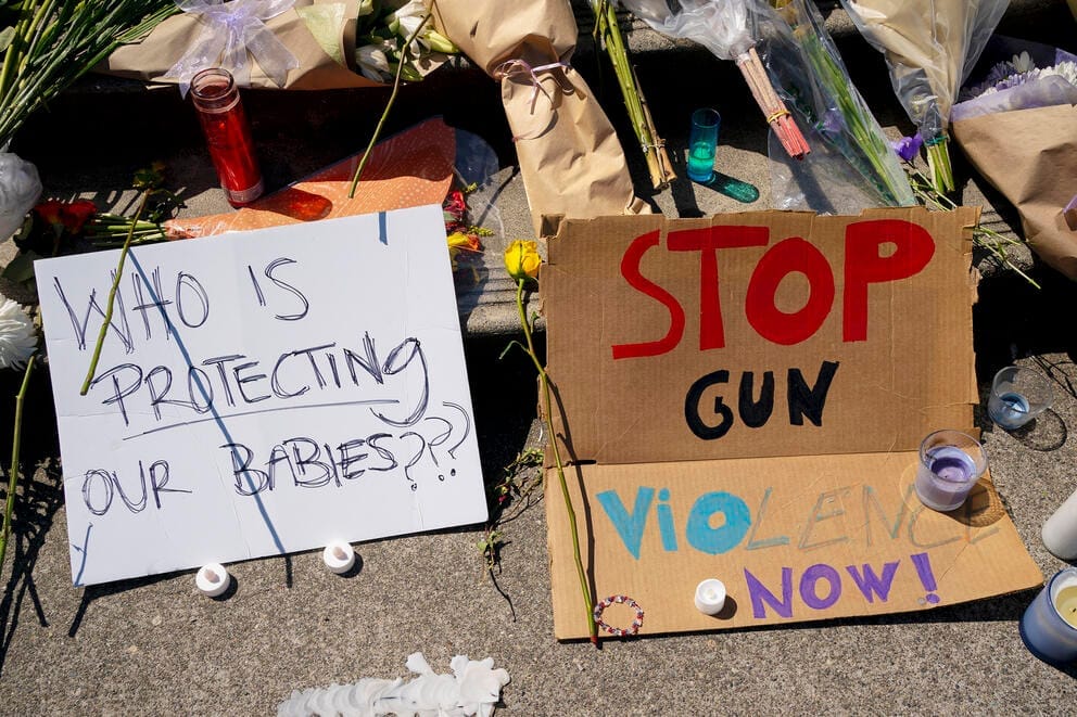 signs at a memorial for a student killed