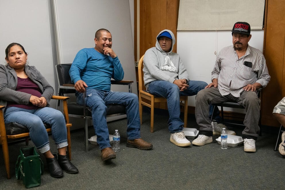 A group of migrant workers meet in Forks, Washington to discuss their difficult working conditions.