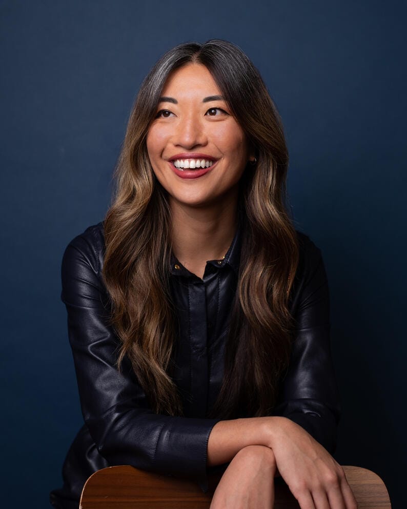 a photo of a woman sitting down and smiling