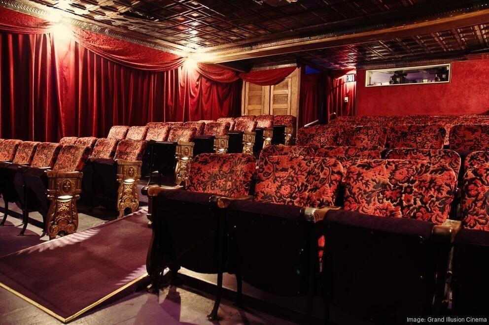 a lush red velvet theater space with low tin ceilings