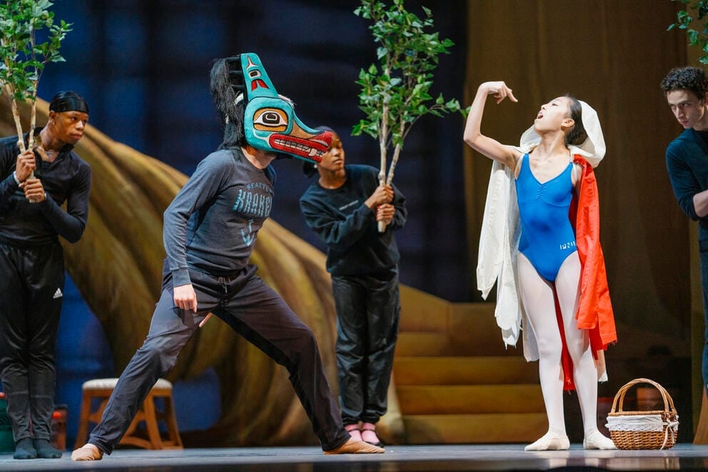 dance rehearsal in which a person in a Kraken t-shirt and wolf mask approached a ballerina in a blue bodysuit and red cape