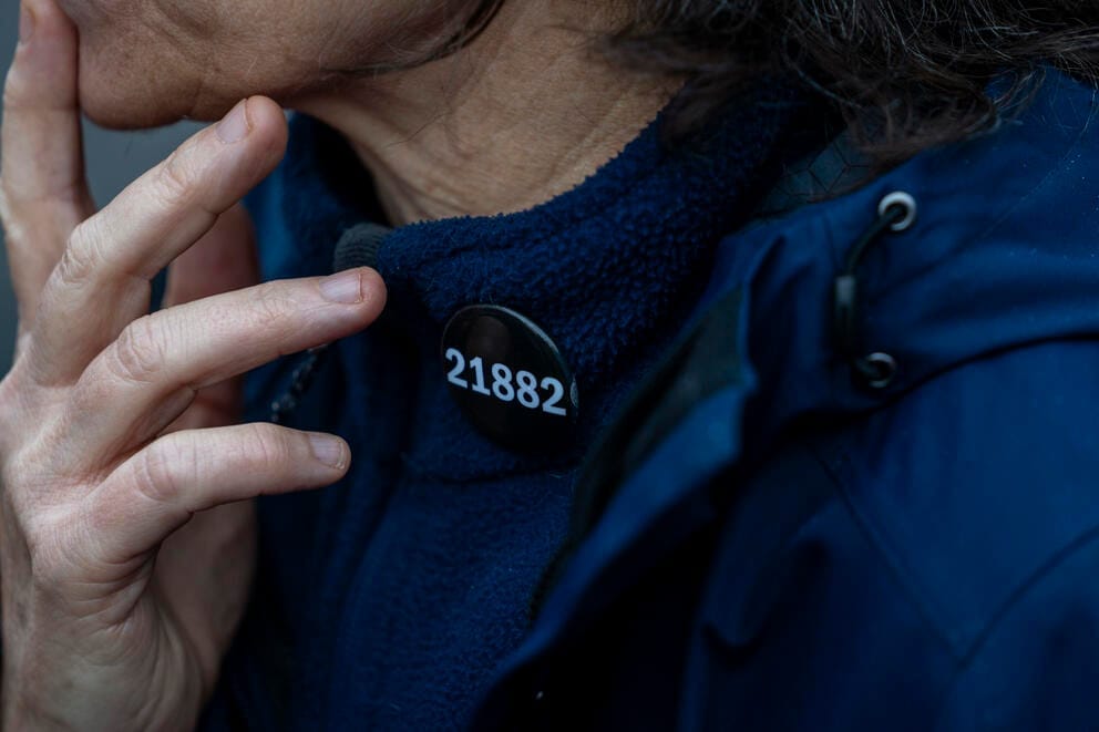 a close up of a button on a woman's collar