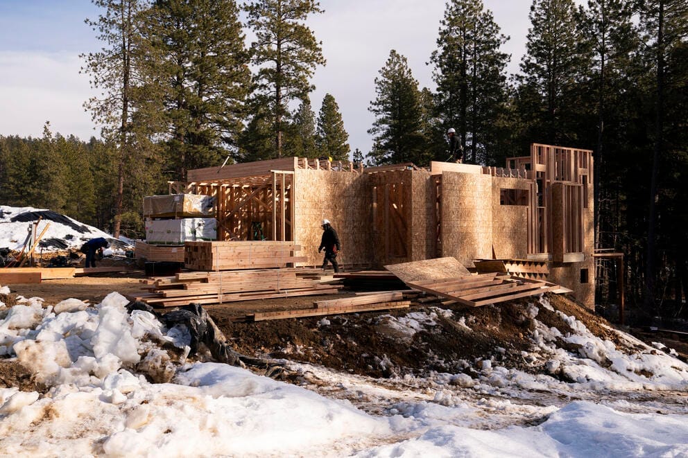 Workers construct a home