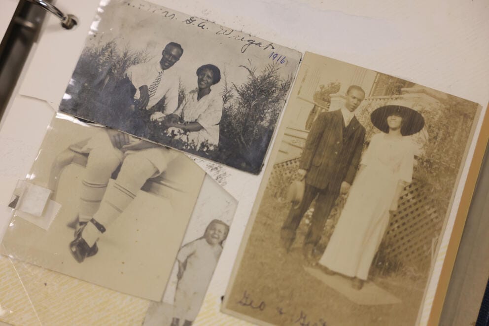 Old black and white and sepia toned photographs of a man and woman inside a photo album