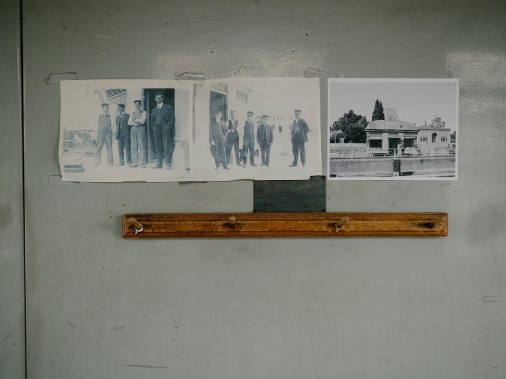 Historic black and white photos are posted on a wall