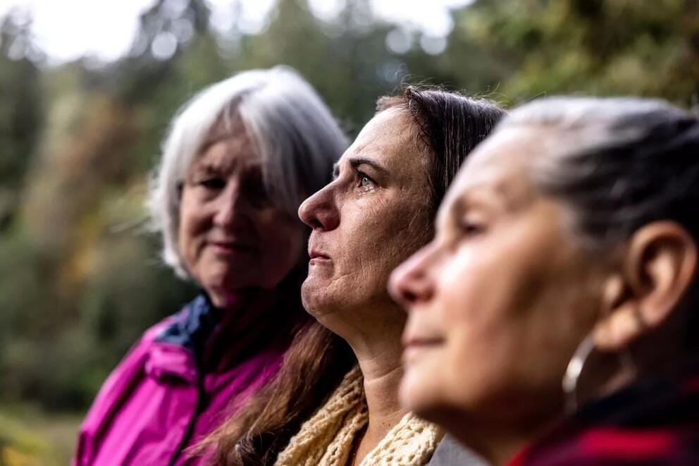 Three people look to the left in a portrait.