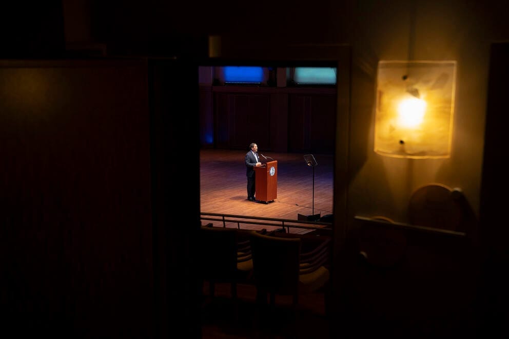 a man on stage delivers a speech