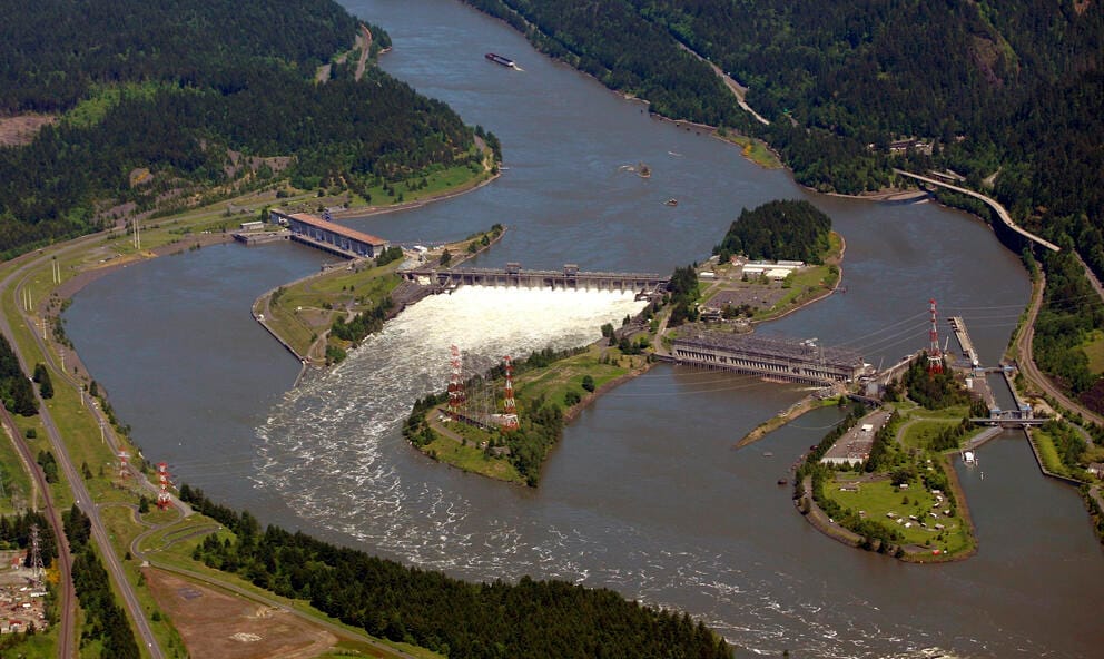 an overhead image of a dam along a river