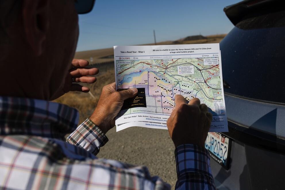 men look at map