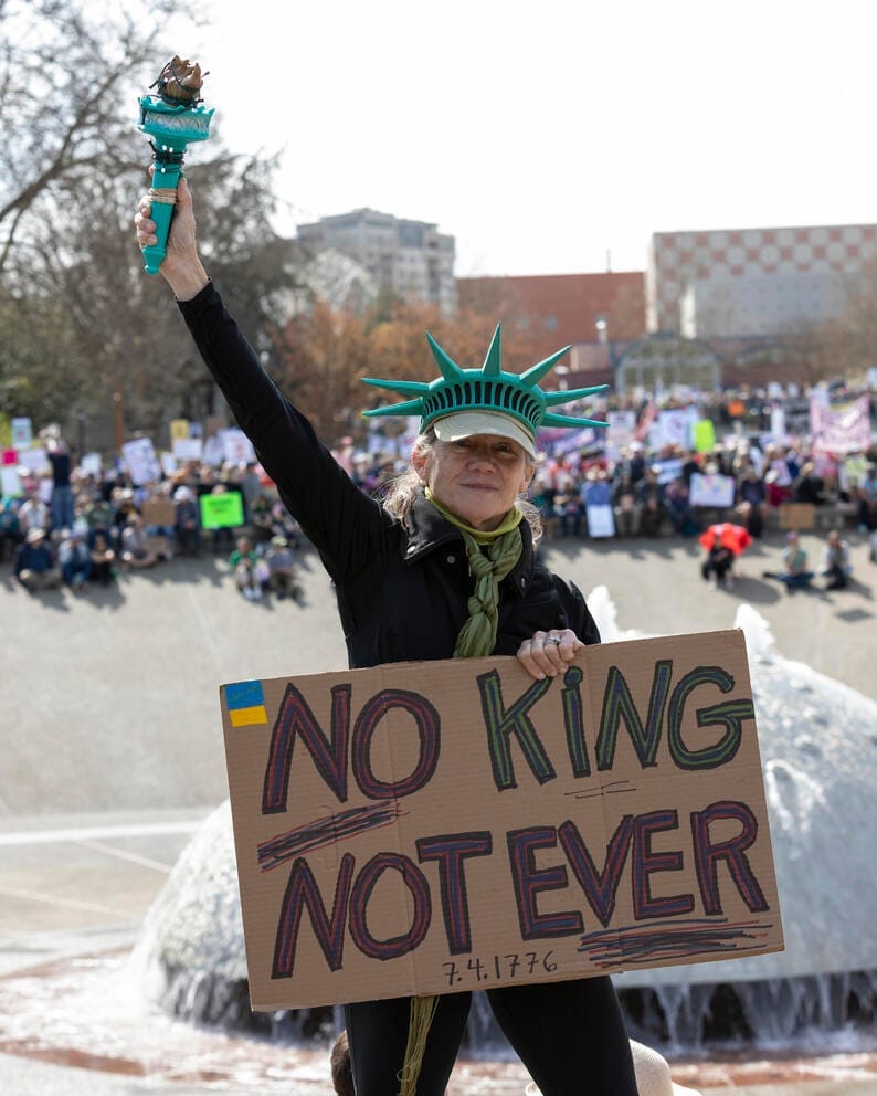 A person holds a sign reading