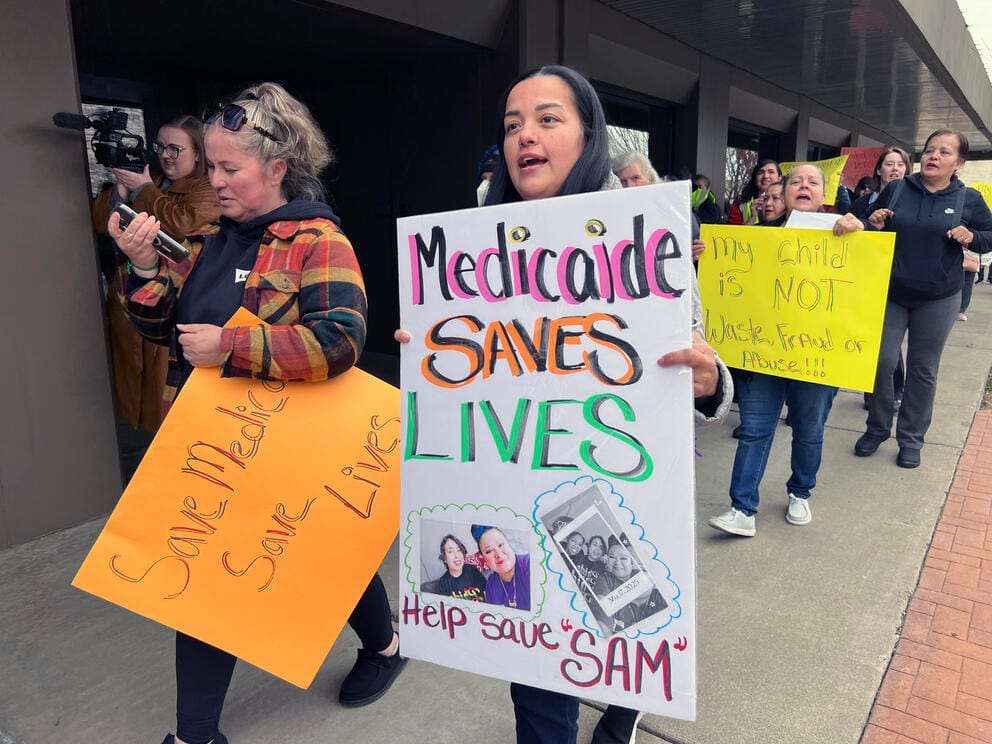 People march outside U.S. Rep. Dan Newhouse's office in Yakima