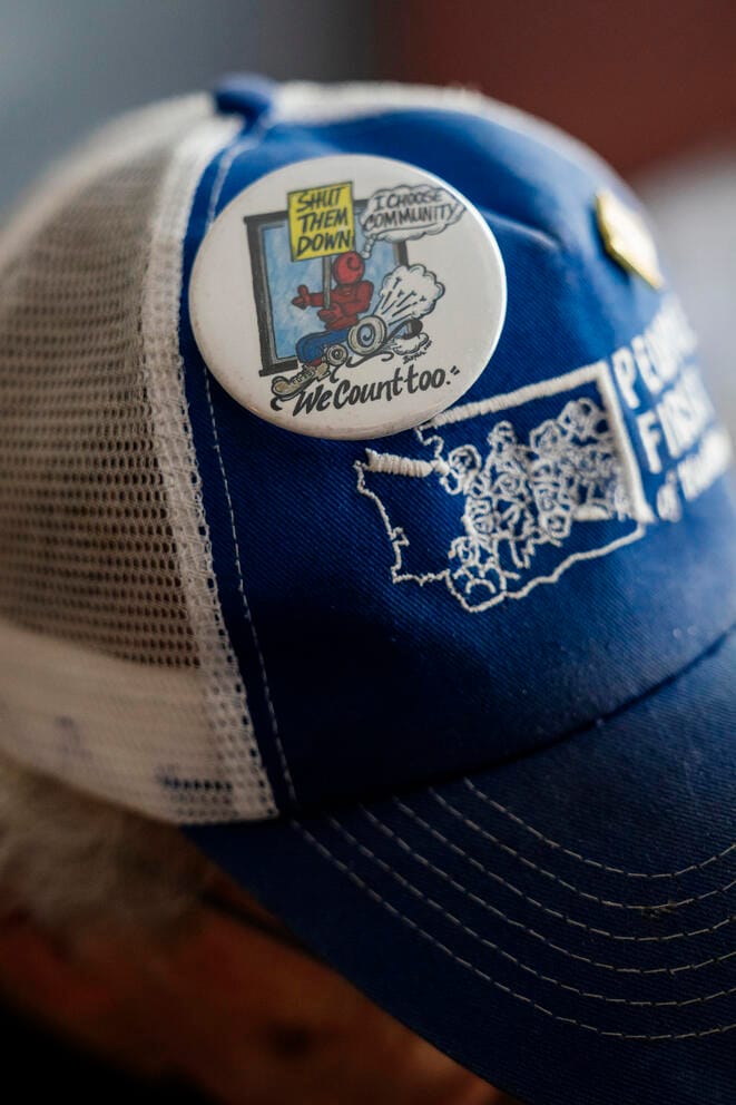 A baseball hat with a pin that says