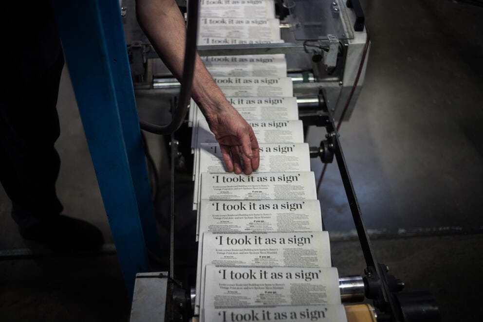 A pressman checks the press