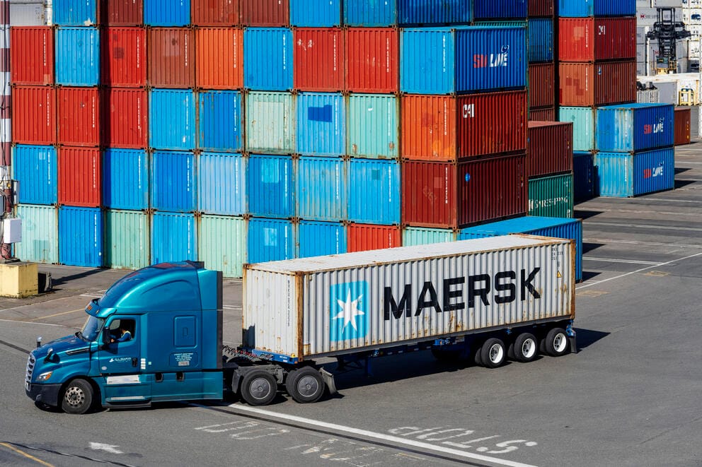 A truck transports a Maersk shipping container