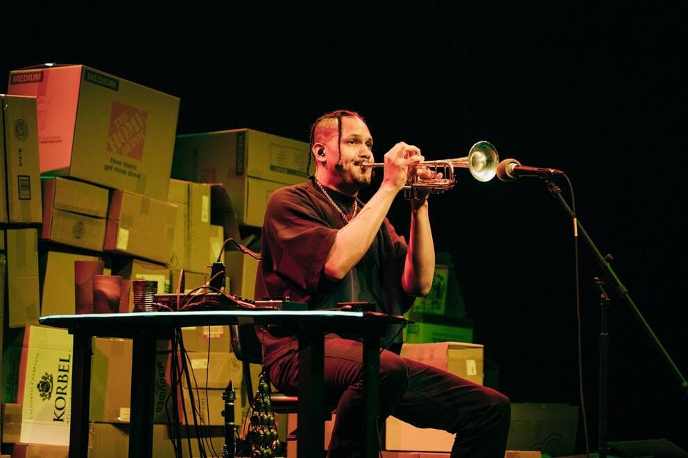 A person plays the trumpet