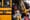 A group of students waits in line to board a big yellow school bus