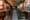 Photo of a hotel lobby with large abstract paintings hung on either side of an open staircase