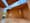 Photo of the interior of an outdoor wooden room with unusually narrow window cuts and open ceiling.