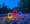 A series of neon sculptures on the shore of a creek