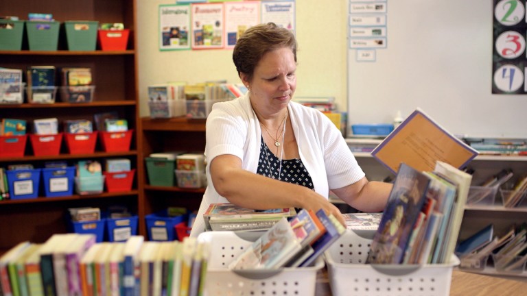 Teacher Dulcey Bean working in her fourth grade classroom after successfully completing breast cancer treatment